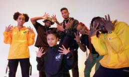 Dance troup of 6 in various poses holding up 10 fingers