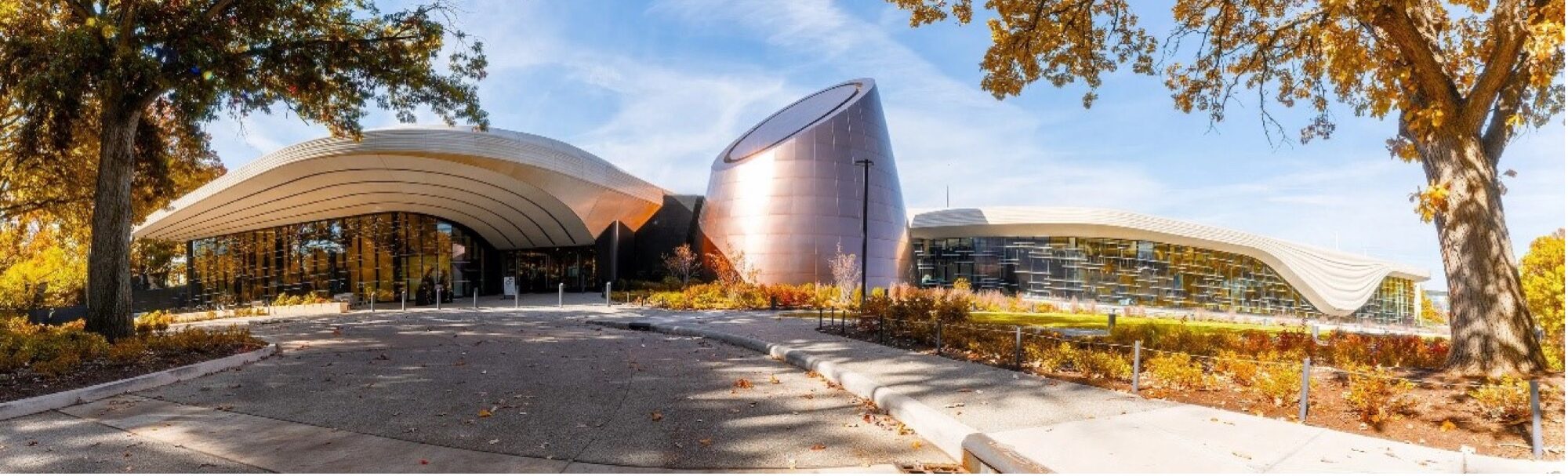 exterior view of the Cleveland Museum of Natural History flanked by trees